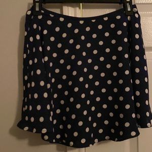 Short navy blue polka dot skirt with zipper, size medium, never worn.